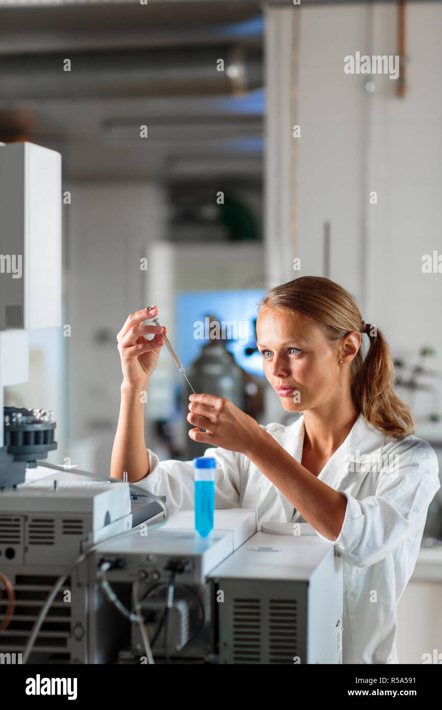 Portrait of a female researcher doing research in a lab, using a tablet computer for data collection and visualization(shallow DOF  color toned image) Stock Photo