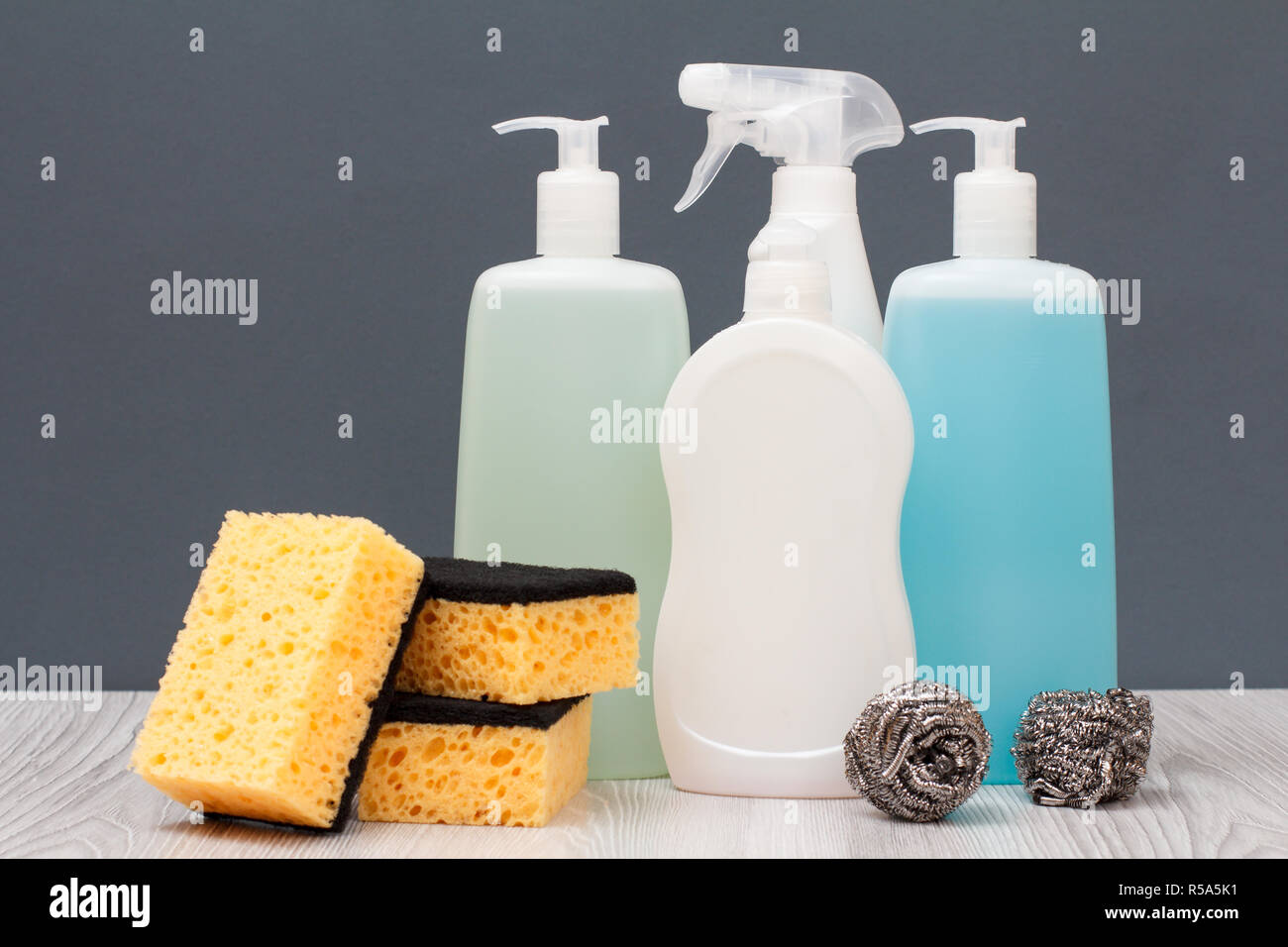 Plastic bottles of dishwashing liquid, glass and tile cleaner