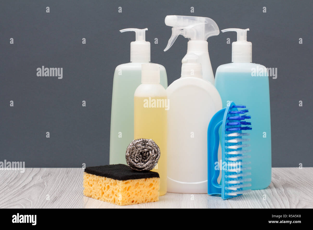 Plastic bottles of dishwashing liquid, glass and tile cleaner