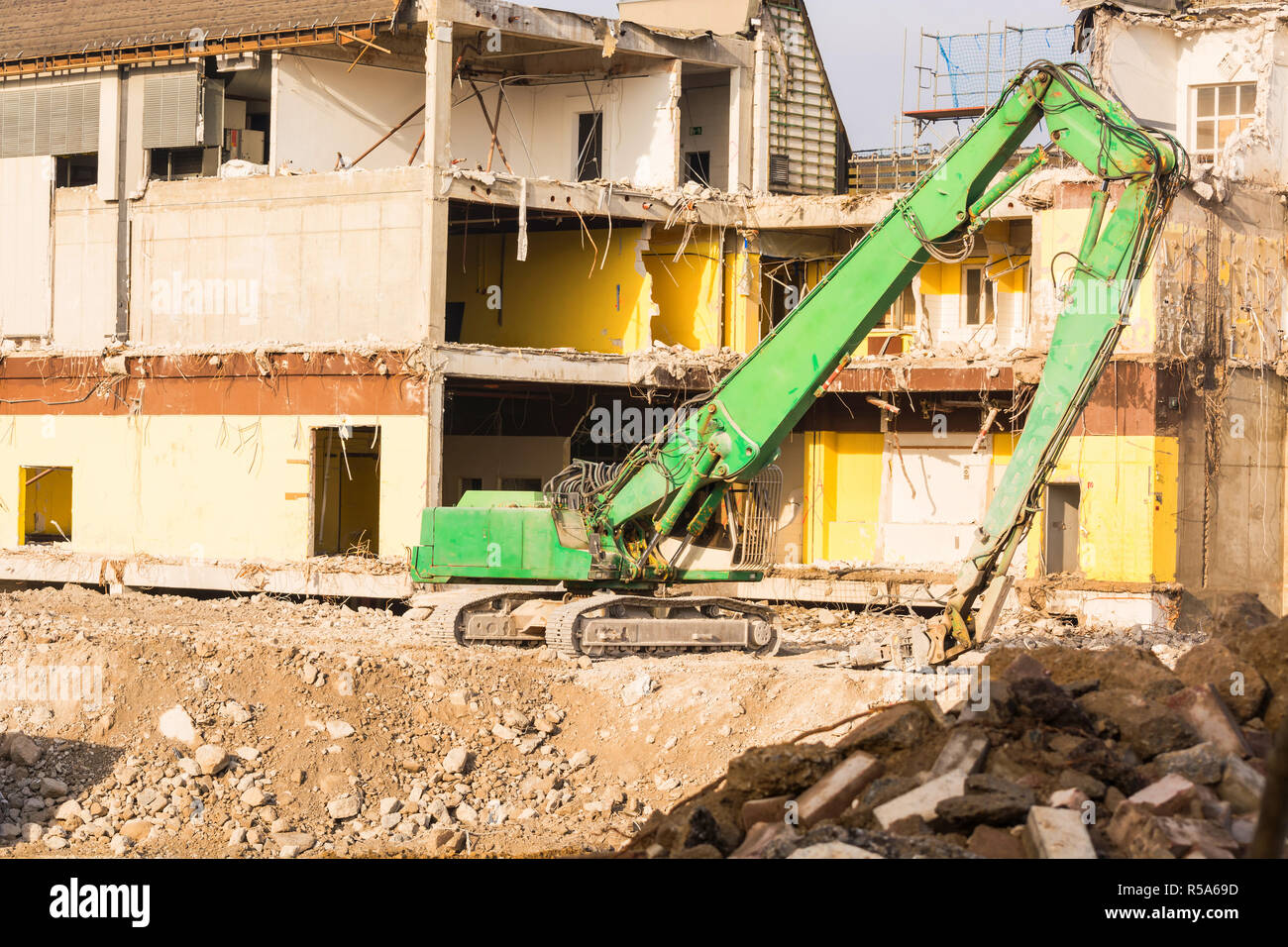 excavator in front of a demolition construction site Stock Photo