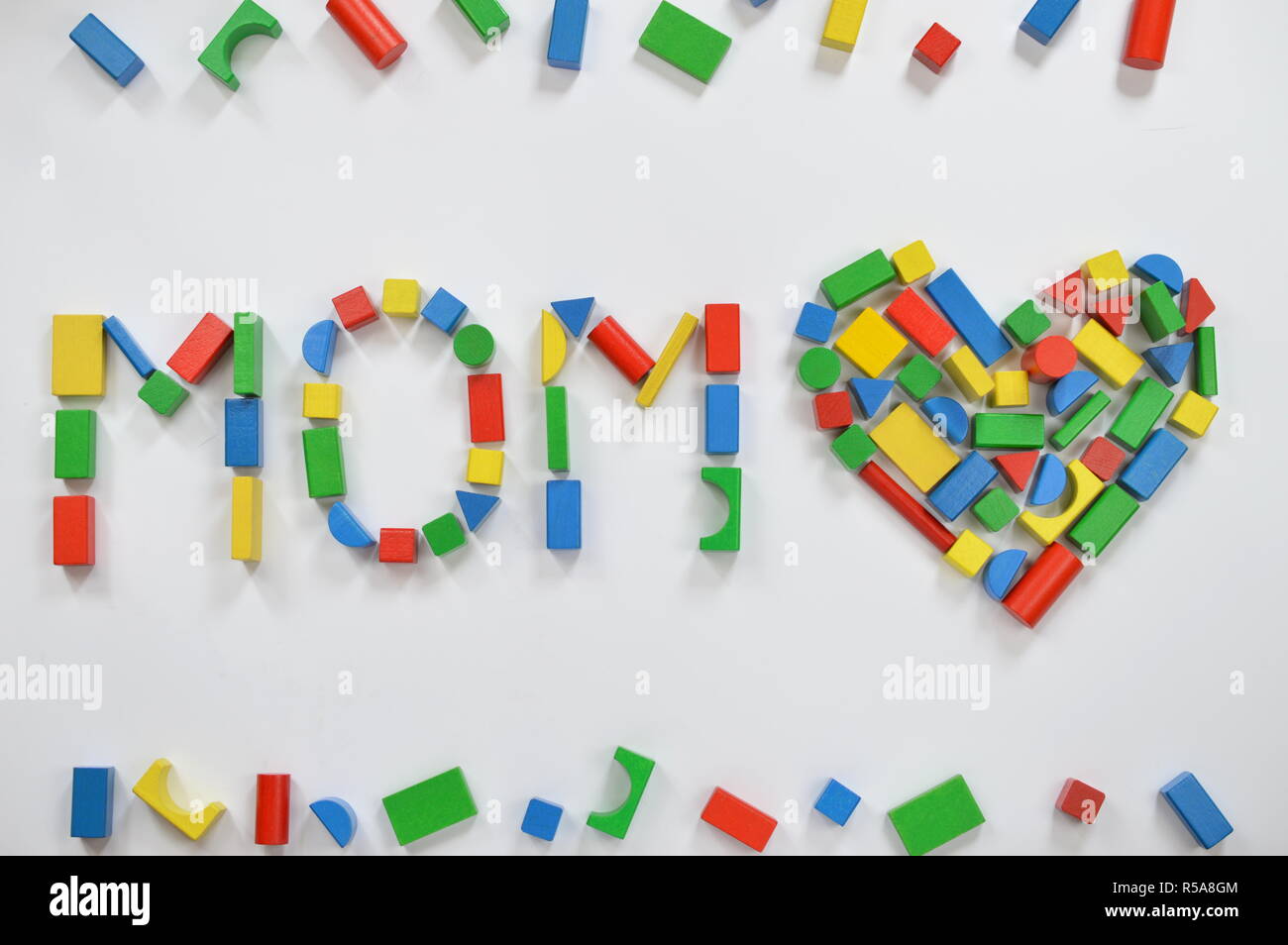 mom and a heart composed of colorful wooden blocks Stock Photo