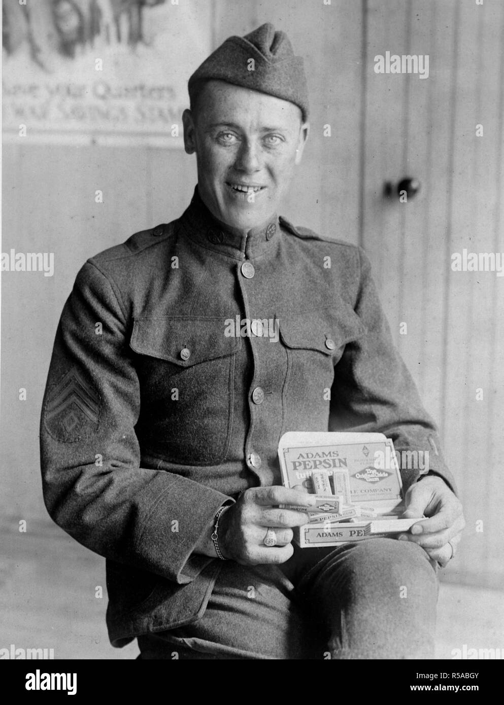 The finished product. An American soldier with a carton of freshly made chewing gum. Every American solider received green receives a regular ration of chewing gum Stock Photo