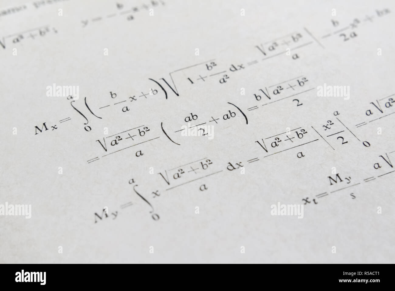 Closeup of a math book and advanced example with integrals Stock Photo