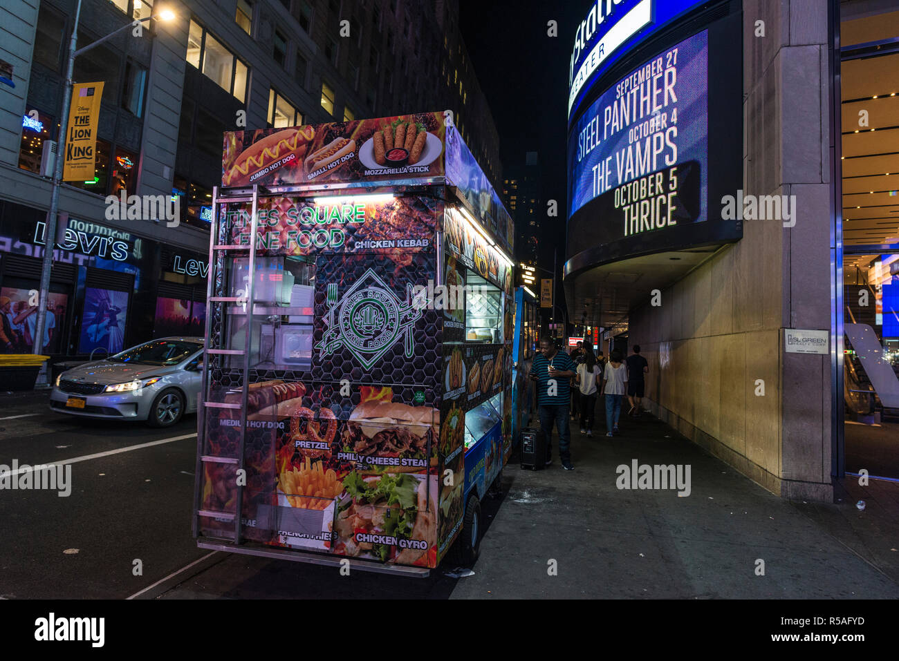 New York City, USA - July 30, 2018: Times Square at night with people around and large advertising screens in Manhattan in New York City, USA Stock Photo
