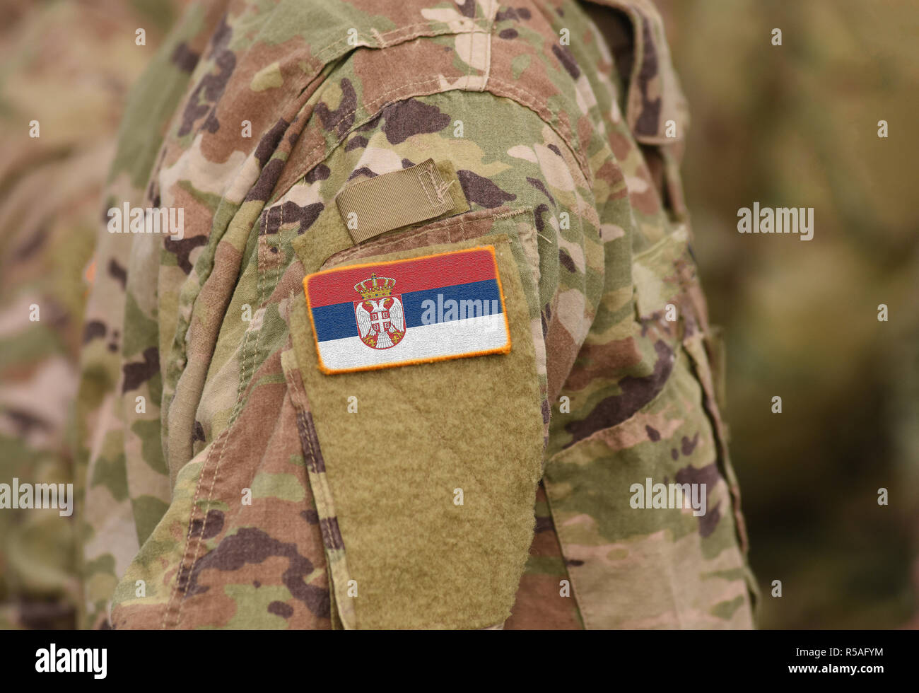 Flag of Serbia on soldiers arm (collage). Stock Photo