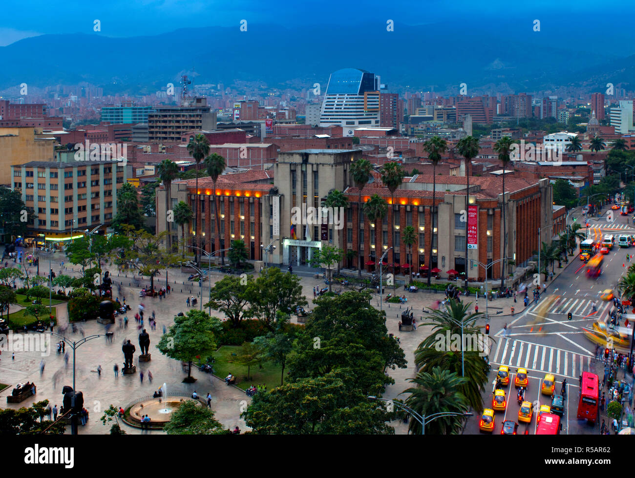 Medellin, Colombia,  Plaza Botero, Sculptures Of Fernando Botero, Museum Of Antioquia, Art Deco, Dusk, Motion, Taxis, Andes Mountains, Aburra Valley Stock Photo