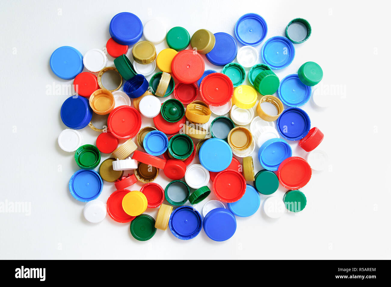 Plastic bottle caps on a white background. View from above. Stock Photo