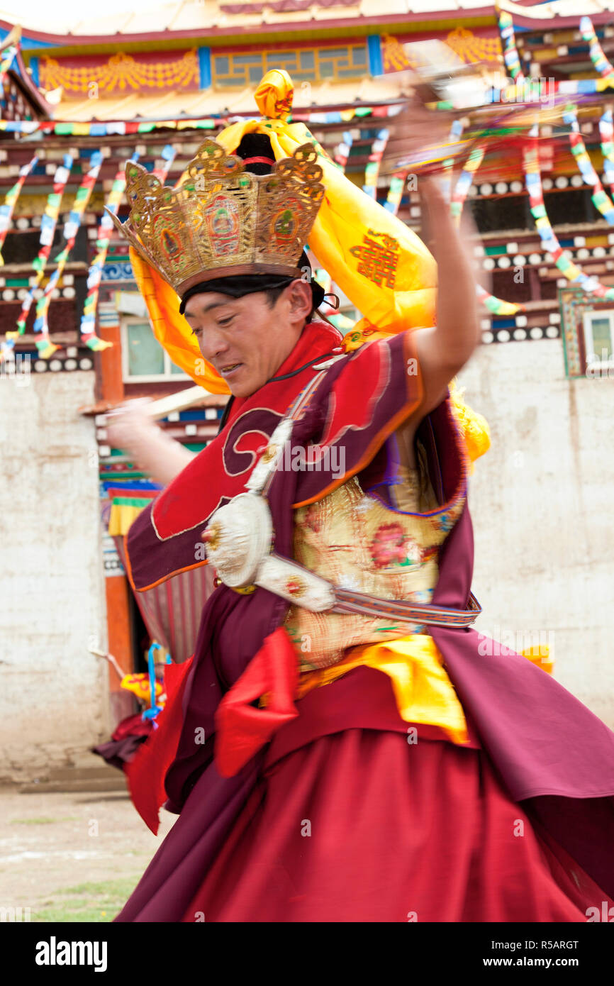 Tibetan monks dancing at buddhist monastery nr Xinlong, Sichuan, China