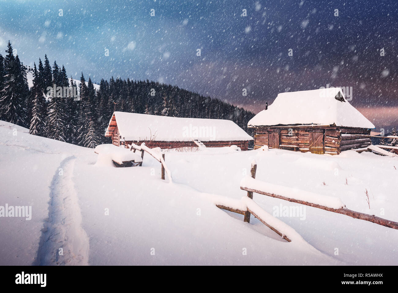 Fantastic winter landscape with wooden house in snowy mountains. Christmas holiday concept. Carpathians mountain, Ukraine, Europe Stock Photo