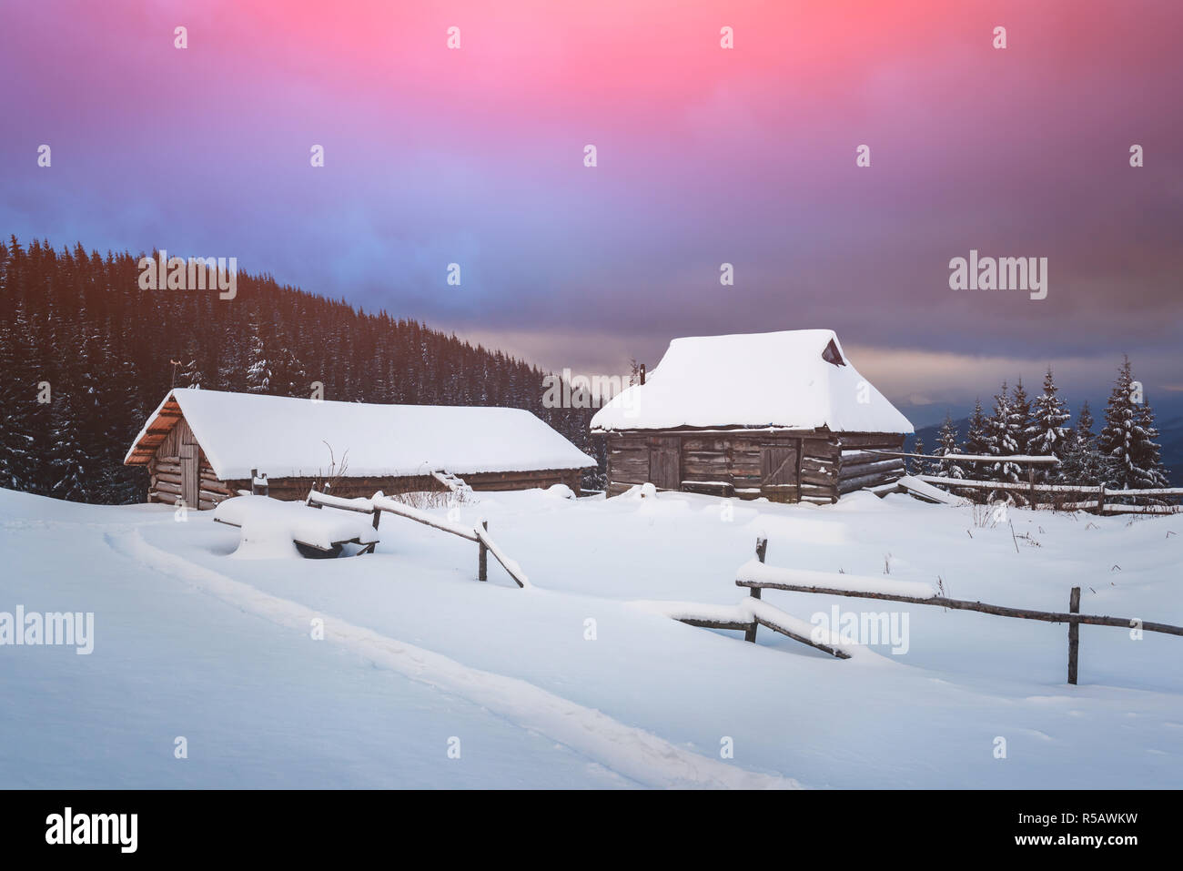 Fantastic winter landscape with wooden house in snowy mountains ...