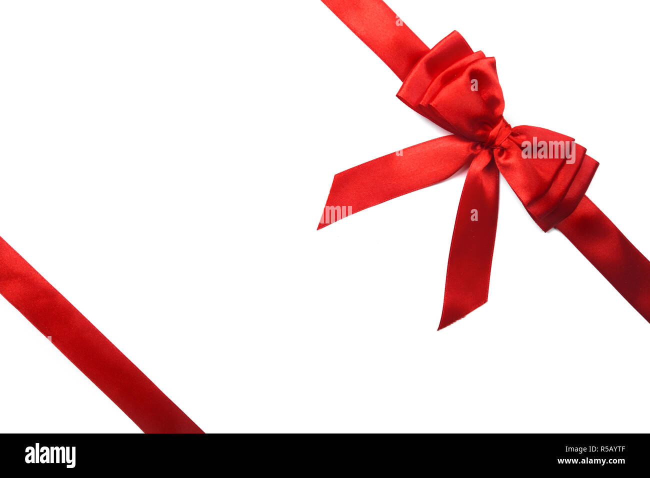 Shiny red satin ribbon on white background Stock Photo
