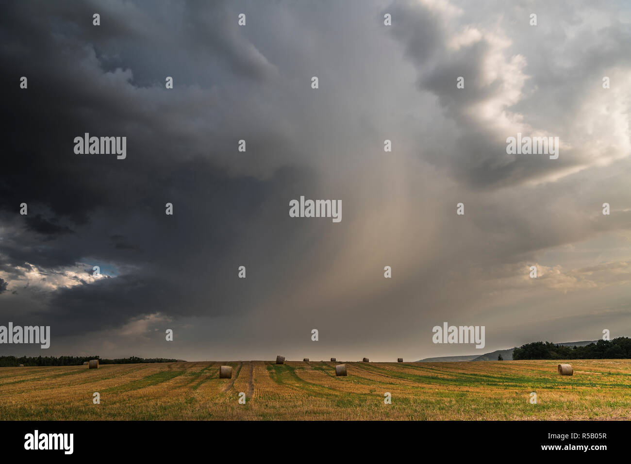 Thunderstorm over stubble field, Thuringia, Germany Stock Photo