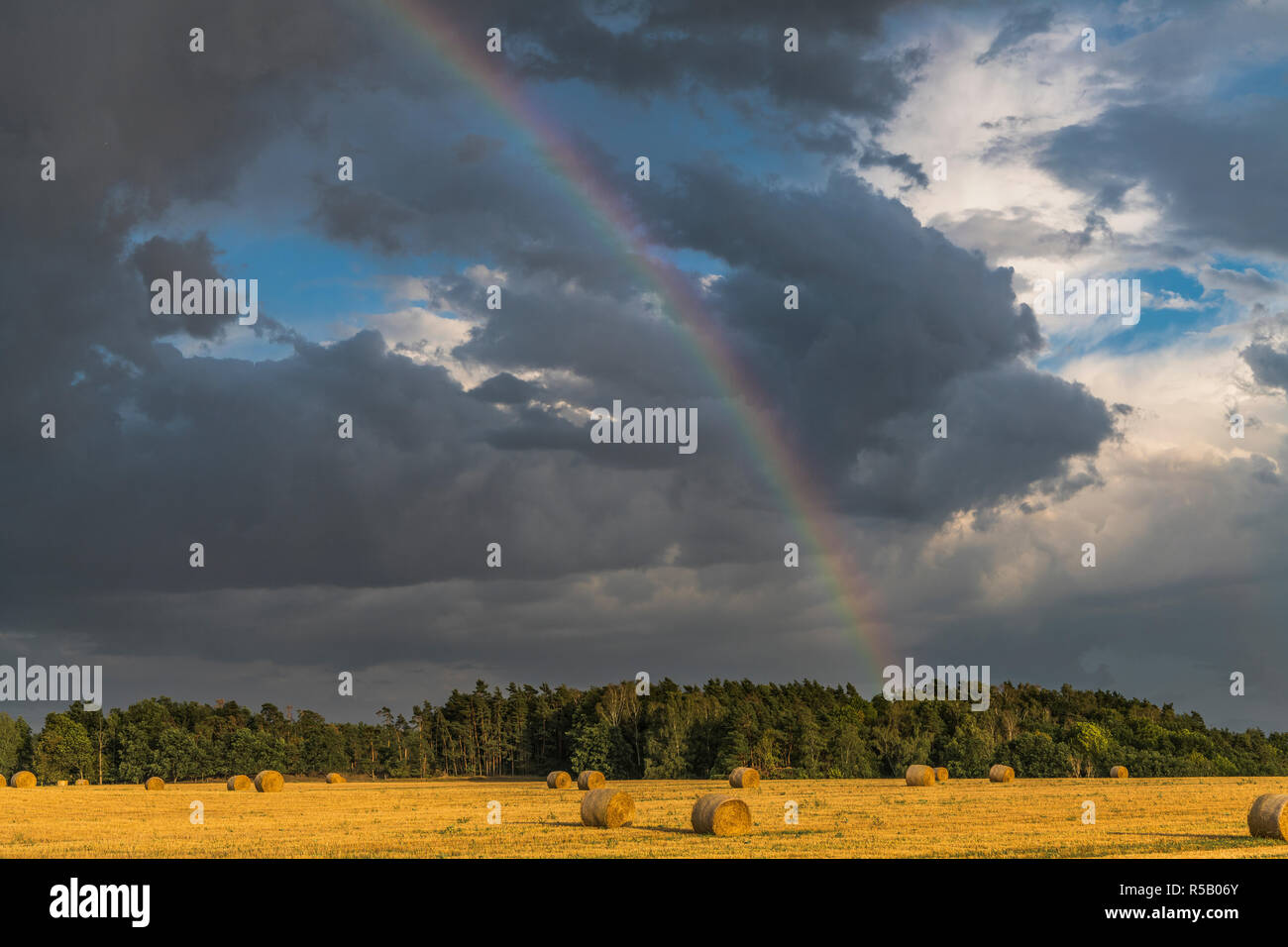 Thunderstorm with rainbow over stubble field, Thuringia, Germany Stock Photo