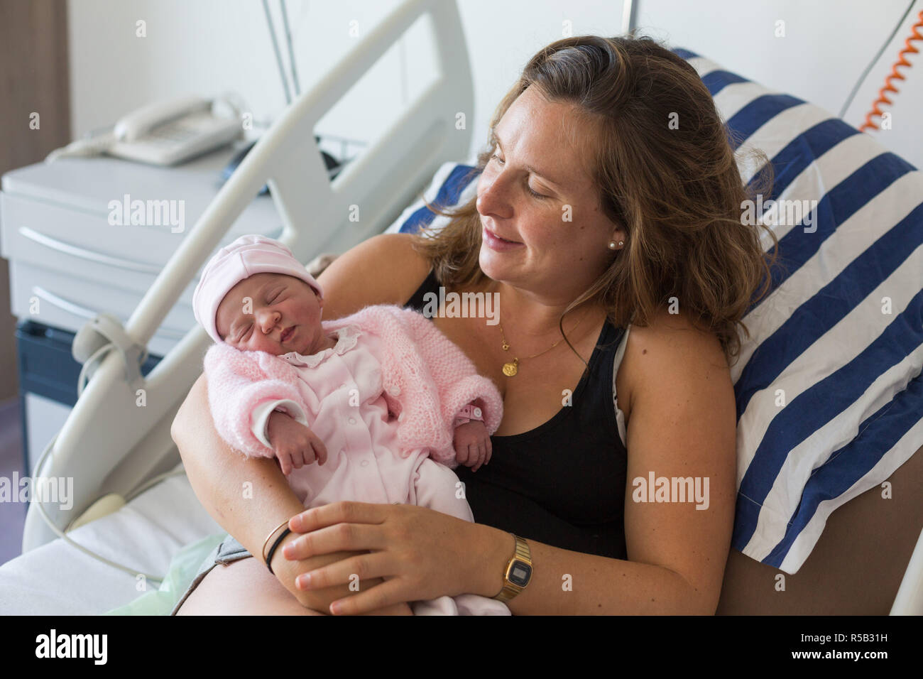 Woman cuddling baby girl hi-res stock photography and images - Alamy