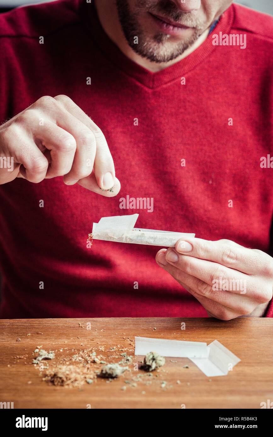 Man rolling a joint Stock Photo Alamy