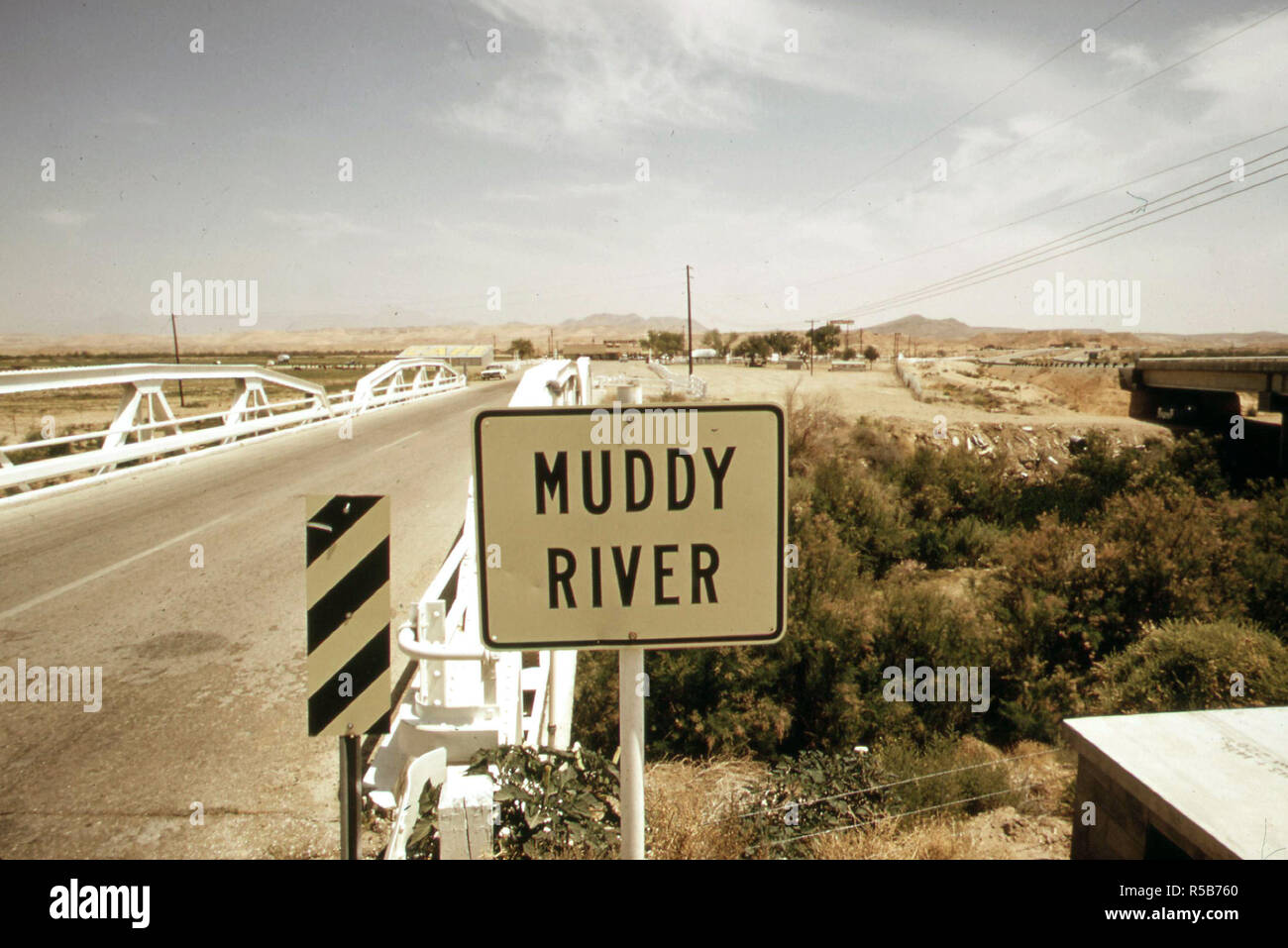 Muddy river and highway crossing, May 1972 (near Las Vegas) Stock Photo