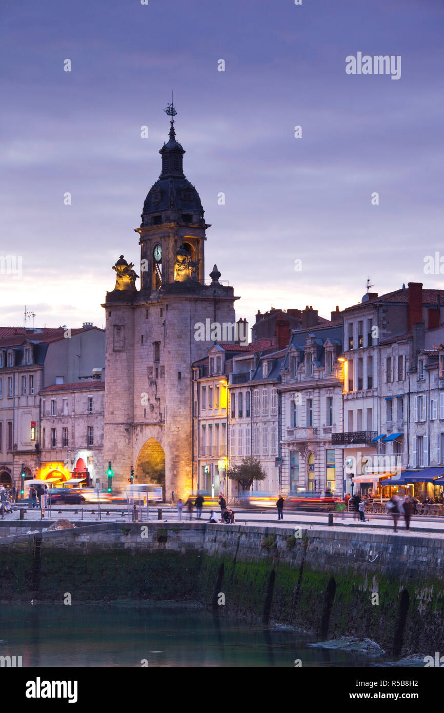 France, Poitou-Charentes Region, Charente-Maritime Department, La Rochelle, Old Port, Porte de la Grosse Horloge, city gate, dusk Stock Photo
