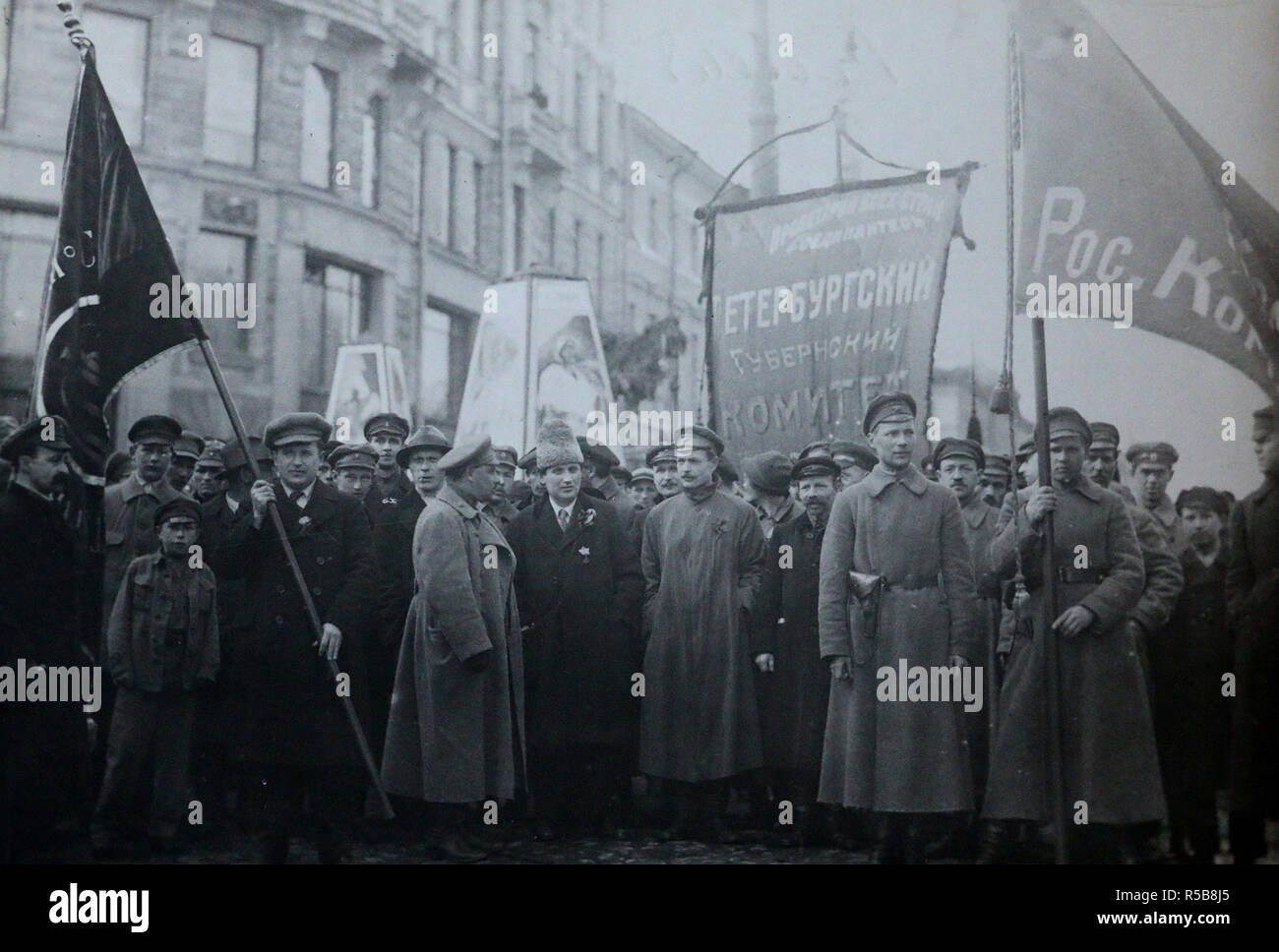 The document shows several Bolshevik leaders in front of a procession for the 1st of May, 1920. In the center, one recognizes Grigori Zinoviev with an Astrakhan. The central banner reads: 'Committee of the Petrograd Province'.  Third on the right from Zinoviev, the man may be Nikolaï Bukharine (1888-1938), member of the Politburo and the Central Committee of the Communist Party, to whom Lenin referred as 'the favorite son of the Party'. Stock Photo