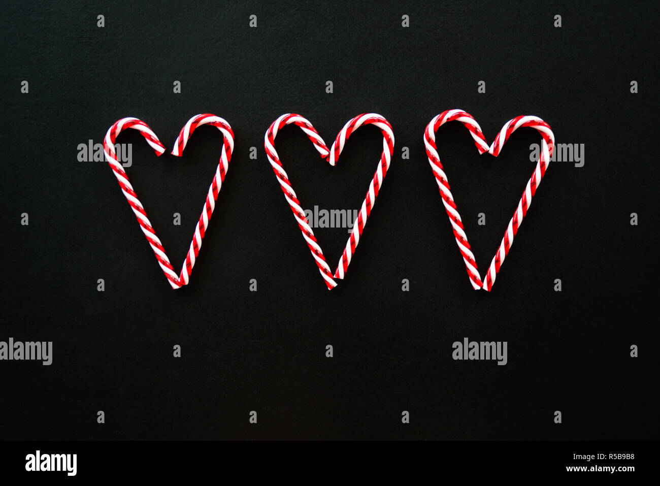 Heart made from candy canes on blackboard Stock Photo