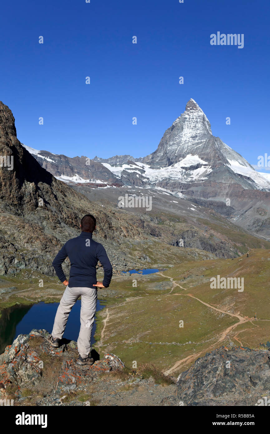 Switzerland, Valais, Zermatt, Hiker near Riffel Lake (MR) Stock Photo