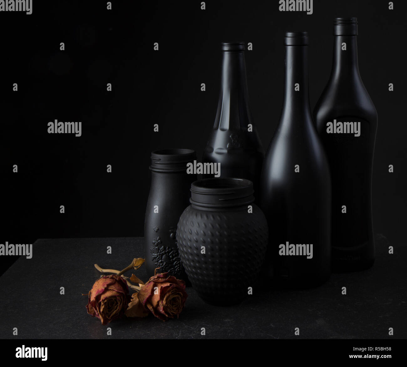 Still of black bottles and 3 roses Stock Photo