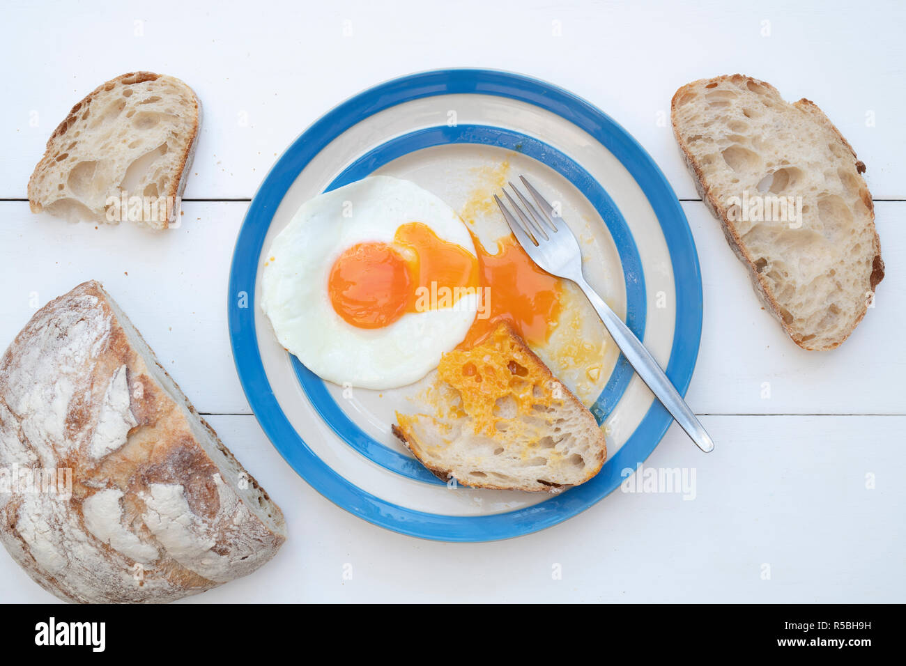 Fried Hens Eggs on a cornishware plate with Sourdough bread Stock Photo