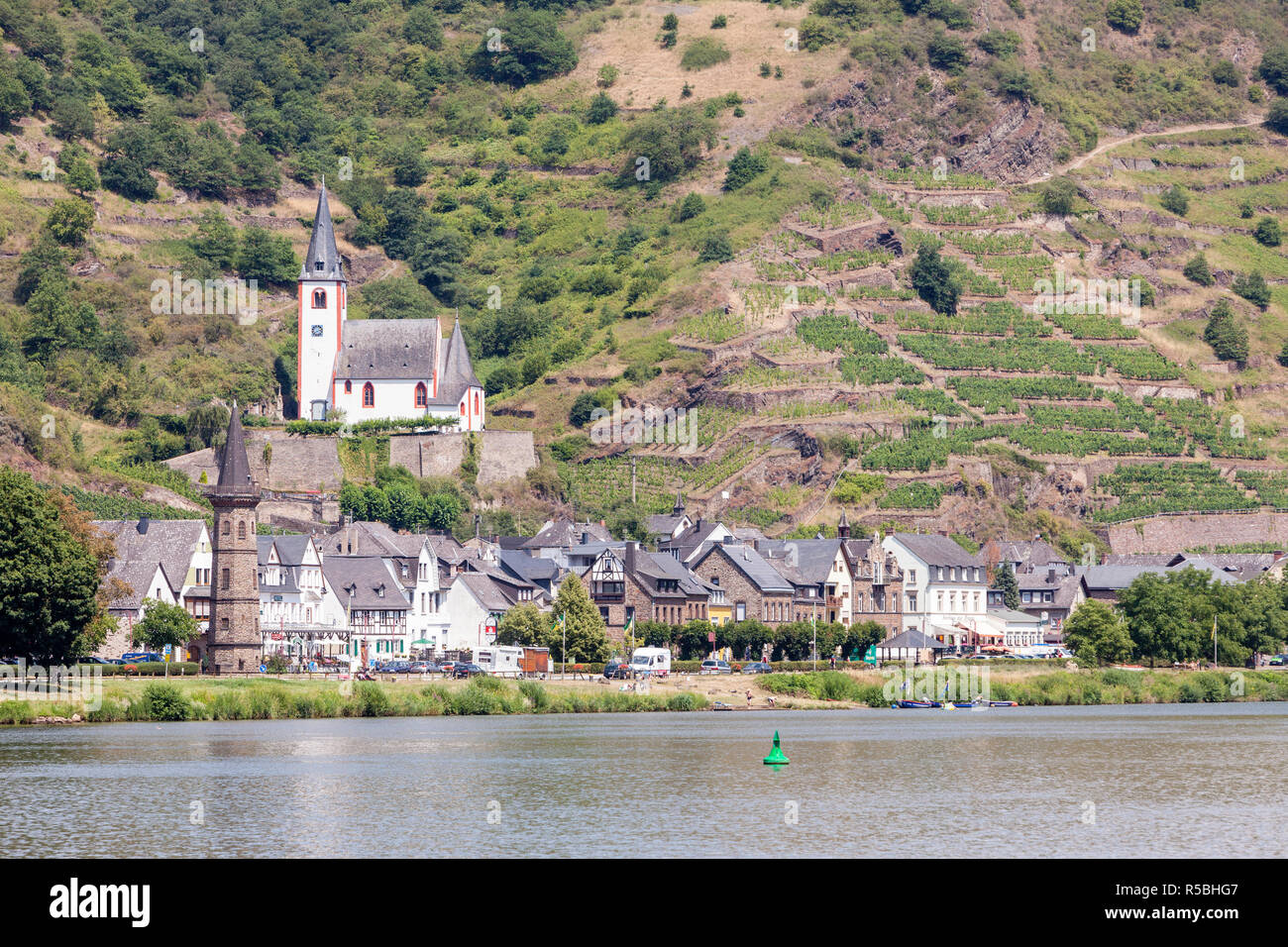 Hatzenport, Germany, on the Moselle.  St. Johannes Church.  Small Vineyards on Steep Hillsides behind the Town. Stock Photo