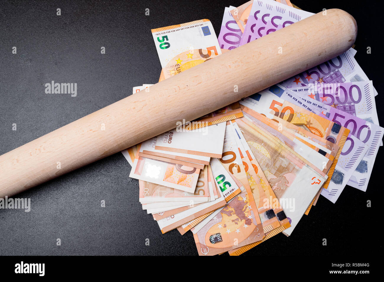 Baseball bat on euro cash money. Corruption concept Stock Photo - Alamy