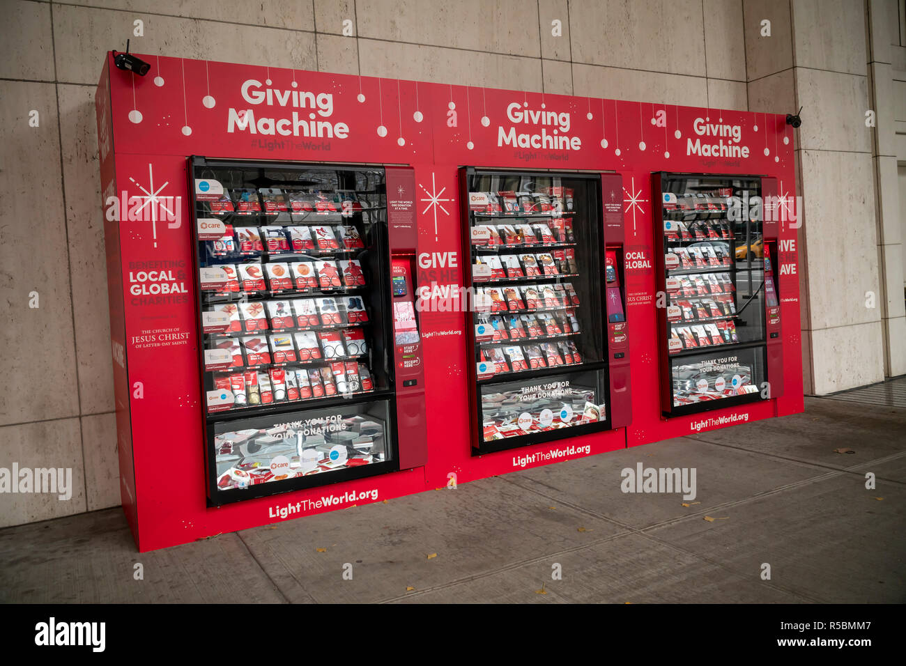 Just in time for #givingtuesday, 'Giving Machines' make their appearance outside the LDS Church in New York on Giving Tuesday, November 27, 2018. The vending machines created by The Church of Jesus Christ of Latter-day Saints enable participants to purchase items, from socks to a goat, that will be distributed to aid organizations. The LDS covers the machines and any associated administrative costs so 100% of the donations goes to the partner charities both local and international. The machines will be around until the end of December. (Â© Richard B. Levine) Stock Photo