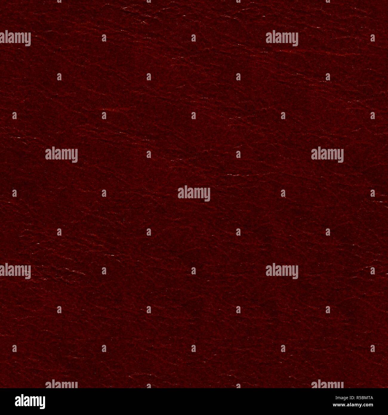 Lackered dark red high quality leather background on macro. Stock Photo