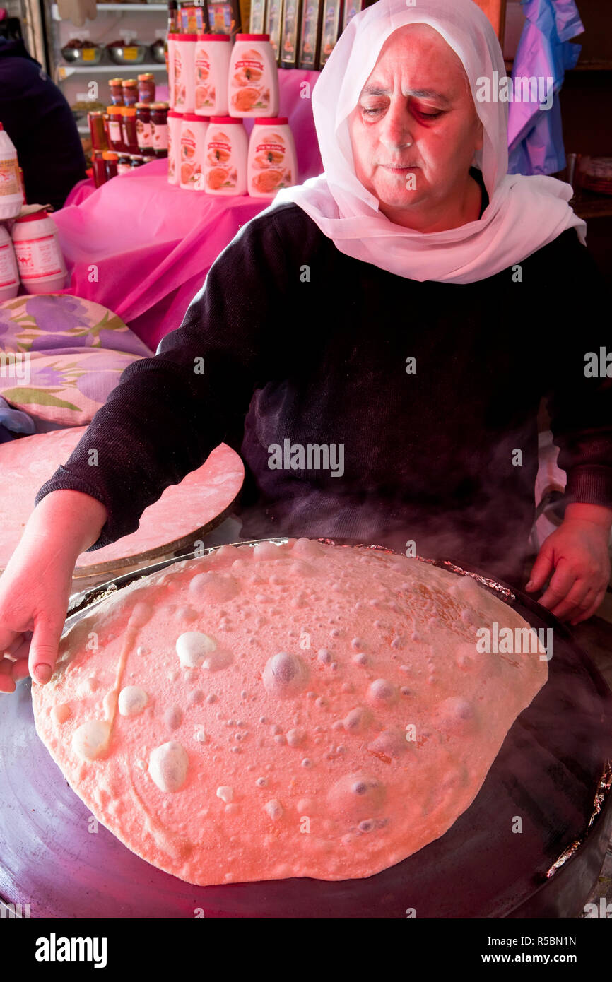 Israel, Tel Aviv, Shuk HaCarmel market, baking traditional flat bread Stock Photo