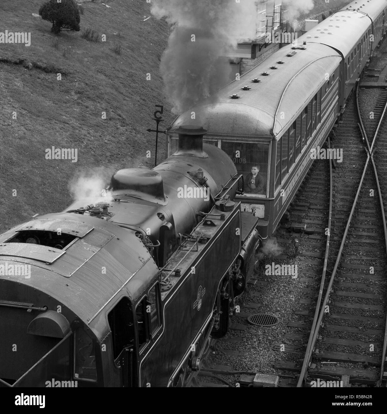 Steam Train in UK, Boy sitting at front in best seat, monotone Stock Photo