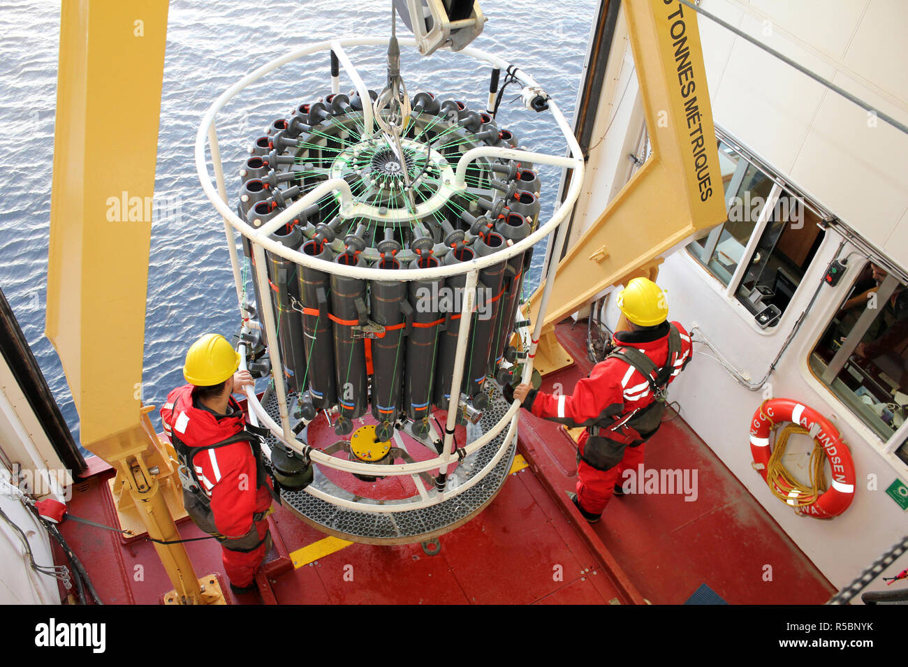 Deploying A CTD Rosette from the CCGS Amundsen during a scientific expedition by ArcticNet and ATLAS scientists Stock Photo