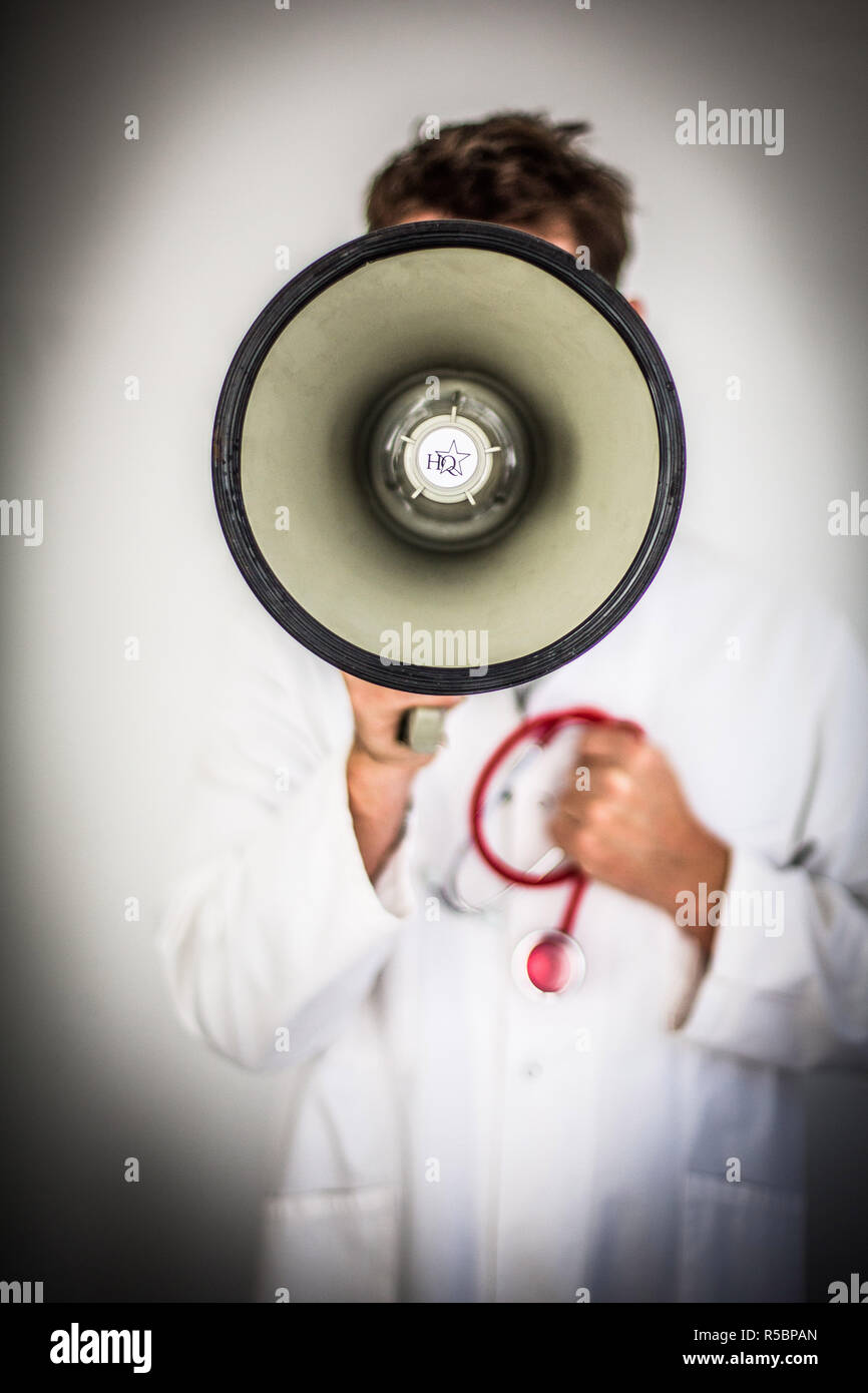 Doctor using megaphone. Stock Photo