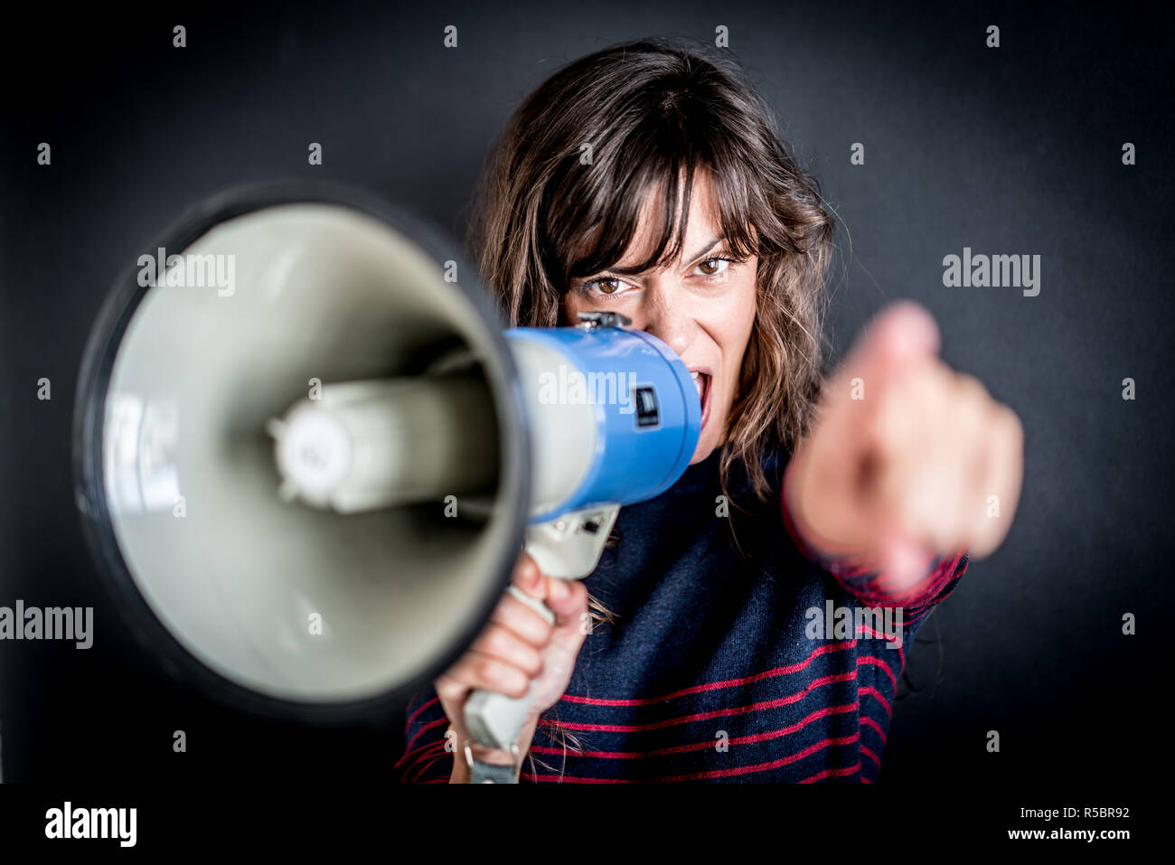 Woman using megaphone Stock Photo - Alamy