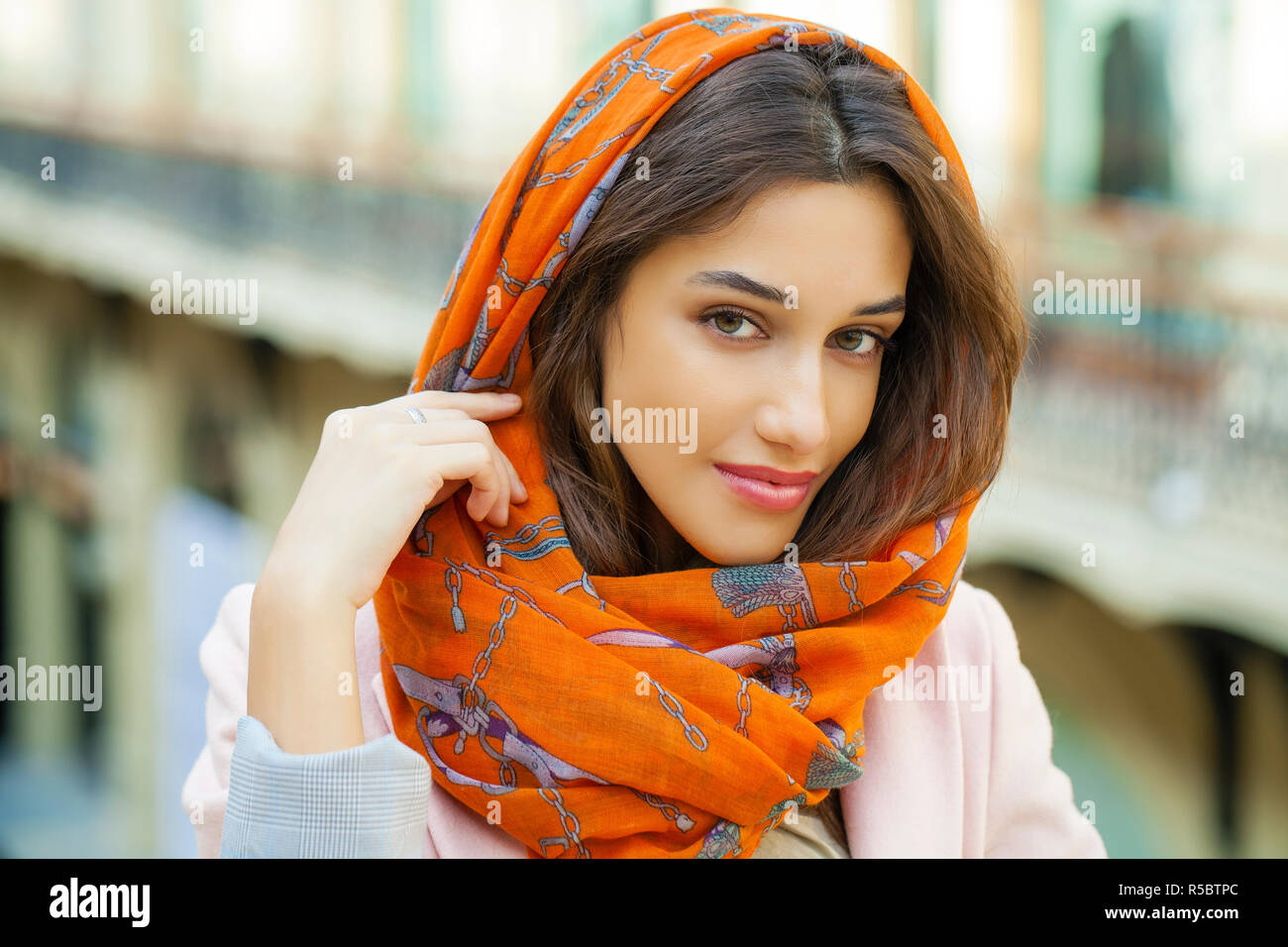 Close up portrait of a muslim young woman wearing a head scarf, indoor ...