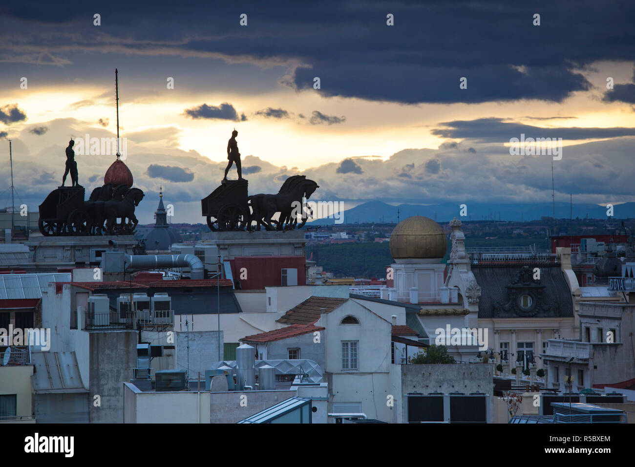 Spain, Madrid, elevated view of figures atop BBVA building, from the Circulo de Bellas Artes Stock Photo