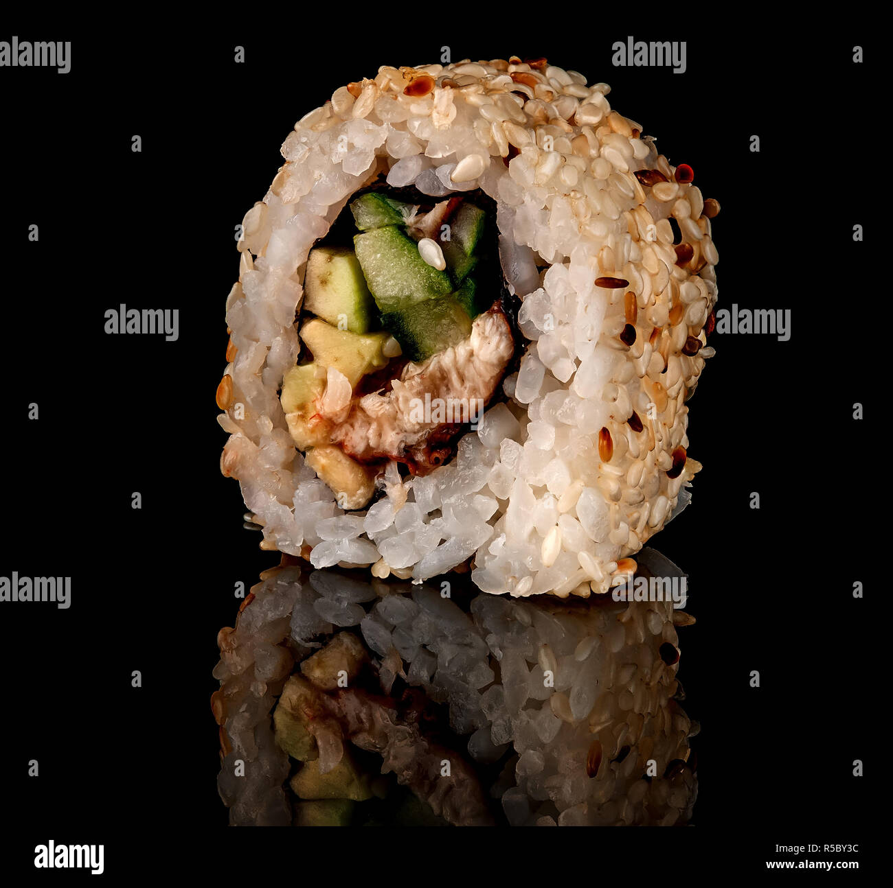 Single sushi roll california rotated. Black background. Reflection Stock Photo