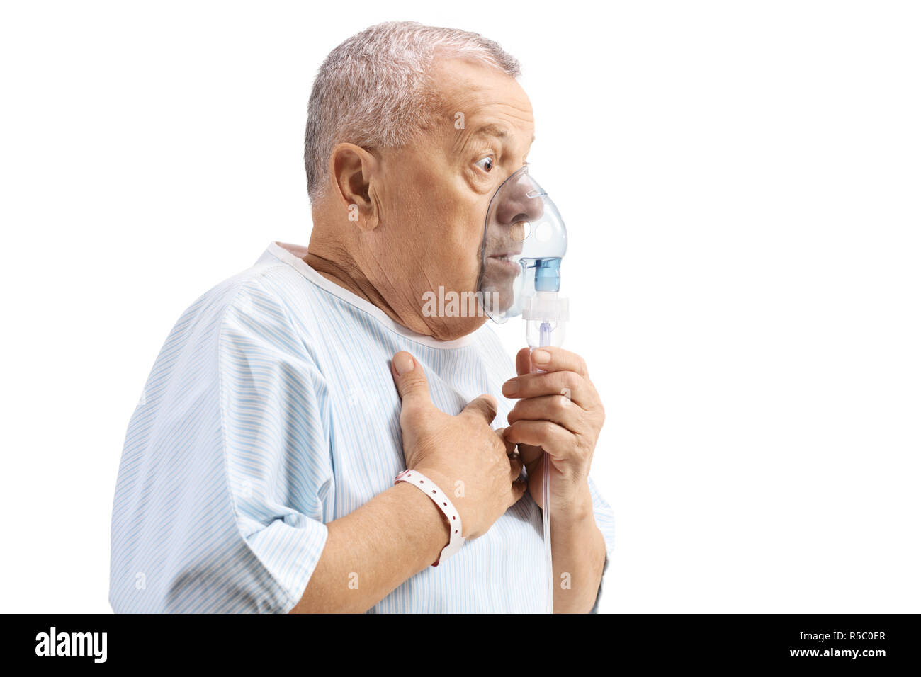 Elderly patient using an inhalation mask isolated on white background Stock Photo