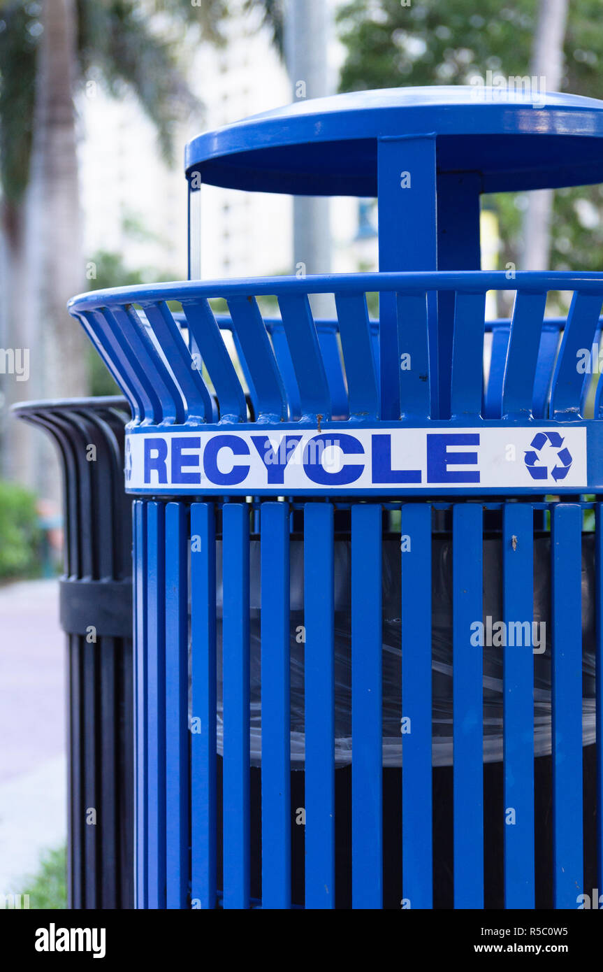 Blue metal recycling bin with the city in the background Stock Photo