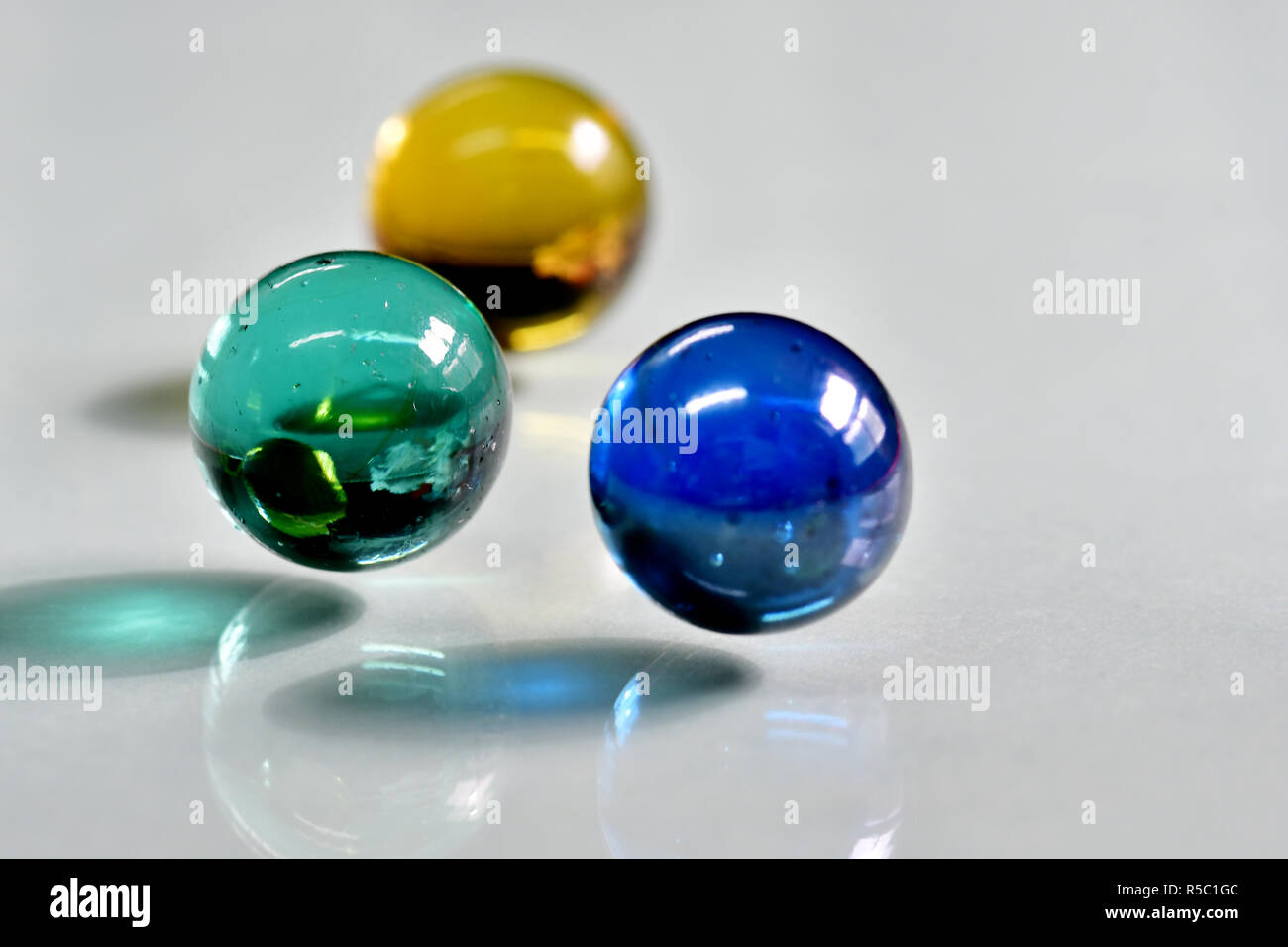 Marbles at close up photo with reflections and shadows. Stock Photo