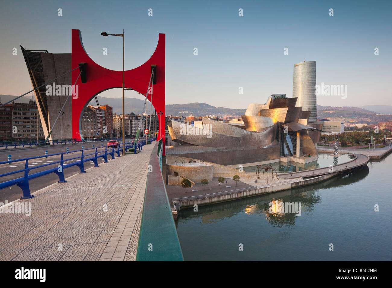 Spain, Basque Country Region, Vizcaya Province, Bilbao, The Guggenheim Museum, and the Puerta Principes de Espana bridge Stock Photo