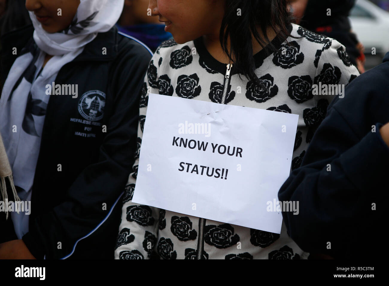 A woman seen with a placard on her chest saying Know your status during ...