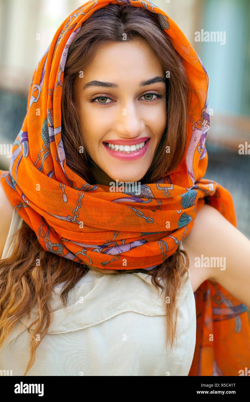 Close up portrait of a muslim young woman wearing a head scarf, indoor ...