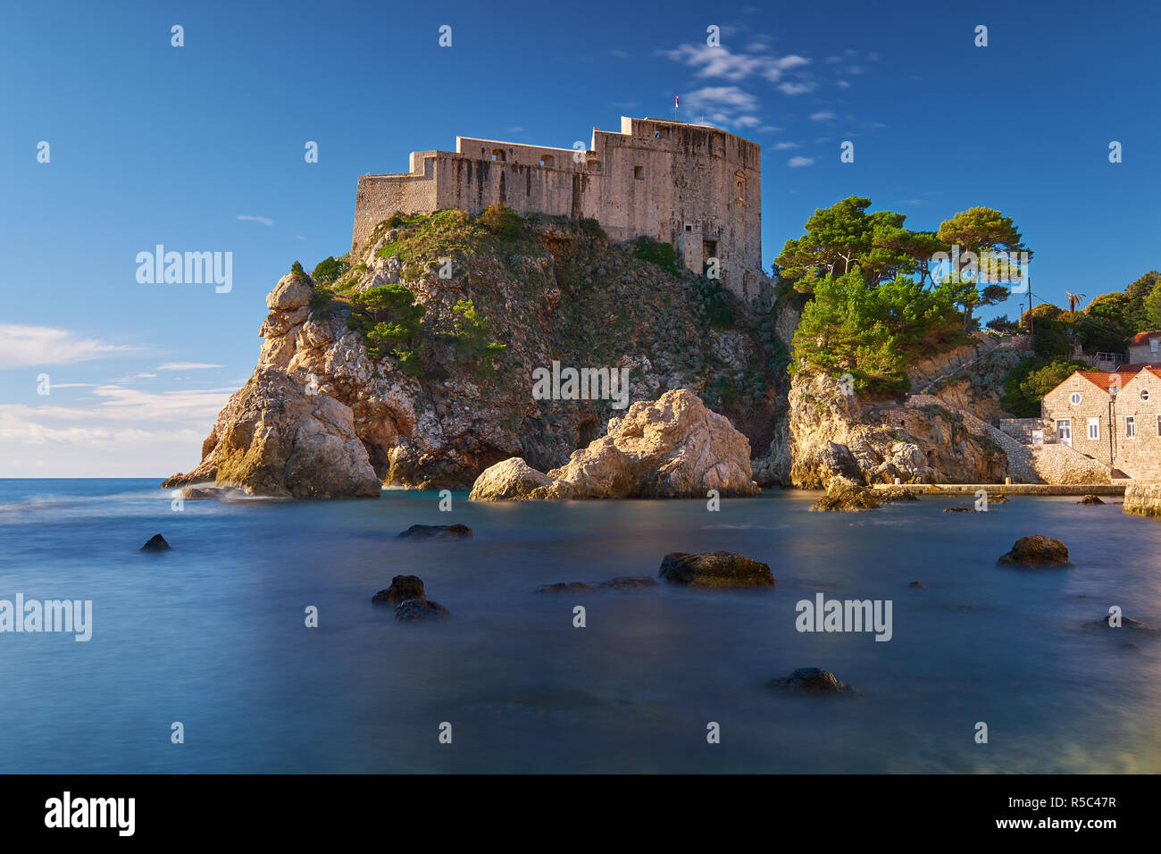 Fort Lovrijenac in Dubrovnic as seen from the beach.  Long exposure to create flat water on a clear bright sunny day. Stock Photo