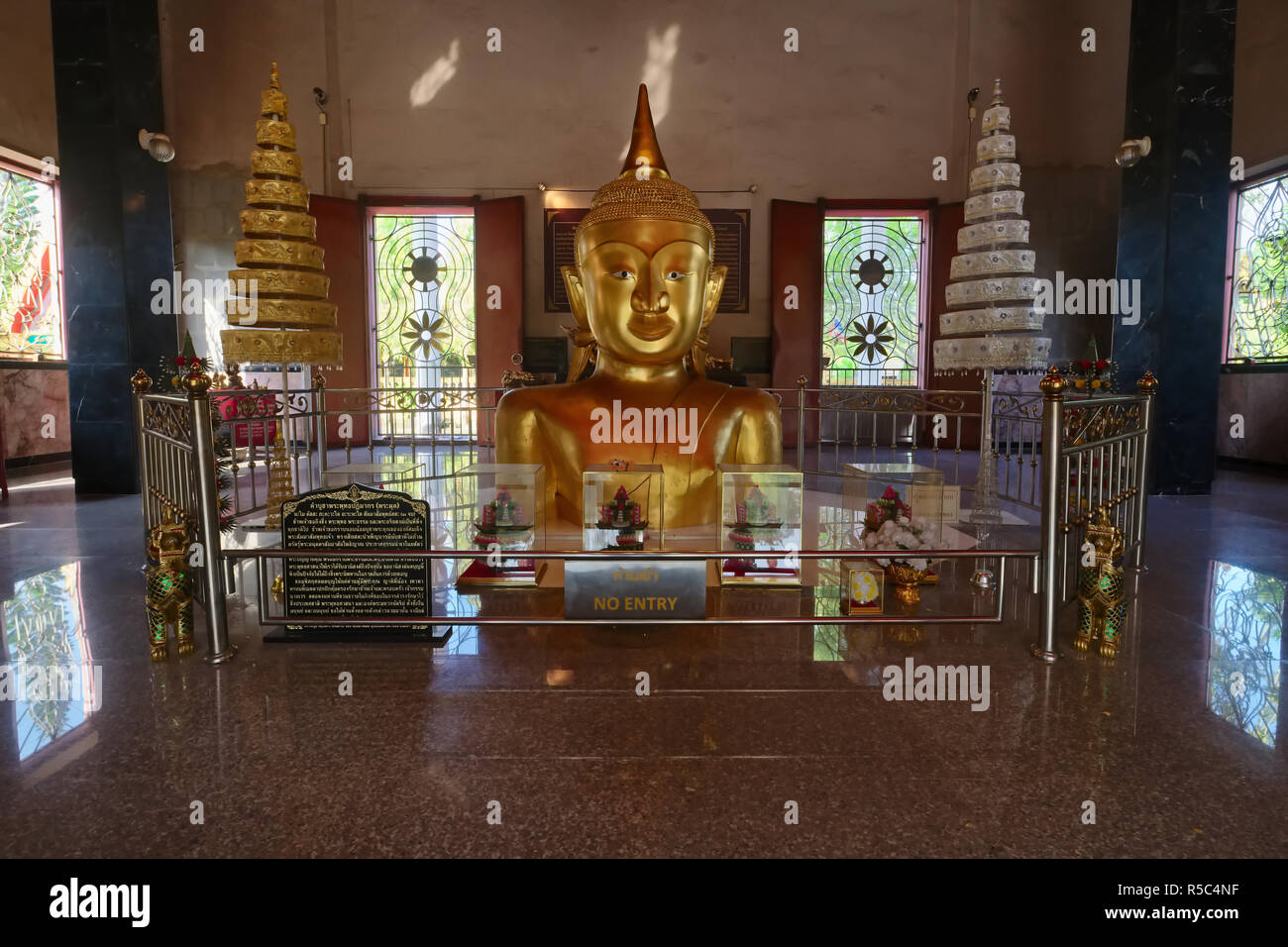 The half-buried golden Buddha statue of Wat Phra Thong, in Thalang, Phuket, Thailand, one of the most visited temples on the island Stock Photo