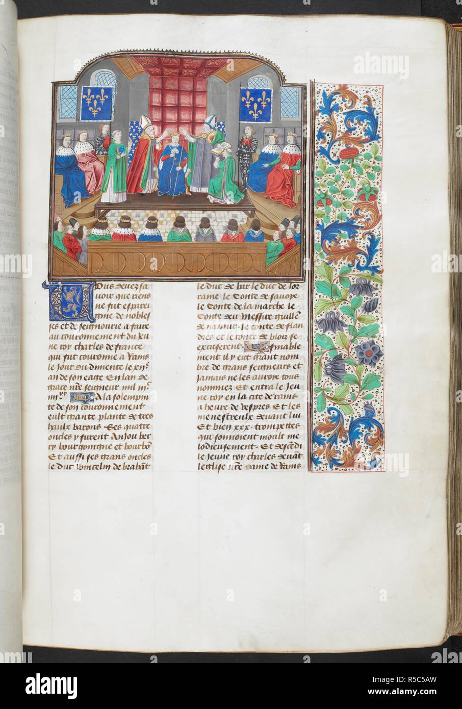 The coronation of Emperor Charles VI. Text and floral border. Chroniques. Netherlands, S. Last quarter of the 15th century, before 1483. Source: Royal 18 E. I f.129. Language: French. Author: FROISSART, JEAN. Stock Photo