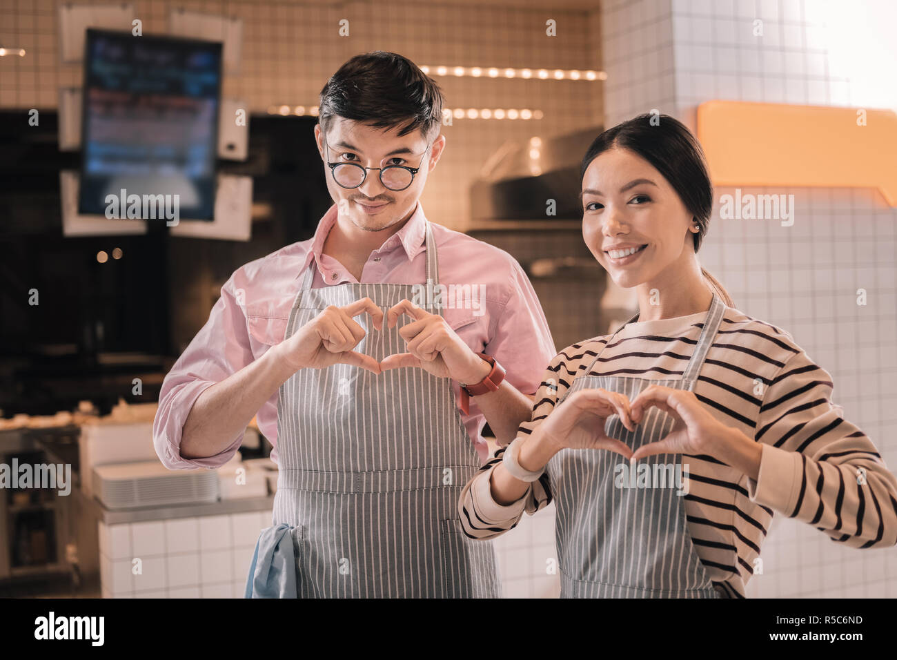 Young couple of successful entrepreneurs opening their own coffee bar Stock Photo