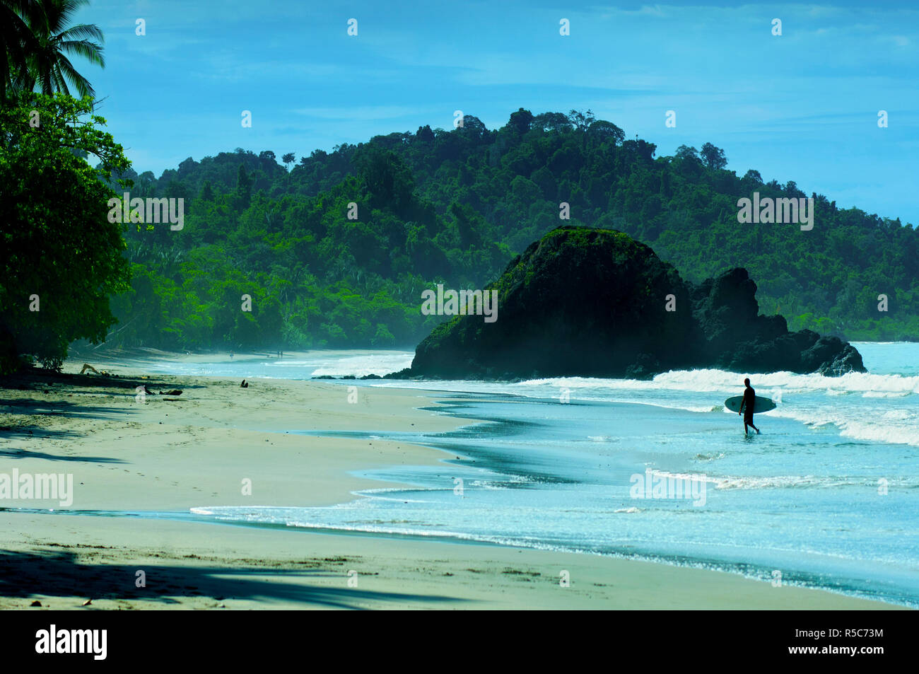 Costa Rica, Quepos, Manuel Antonio, Beach, Rainforest, Pacific Ocean, Surfer Stock Photo