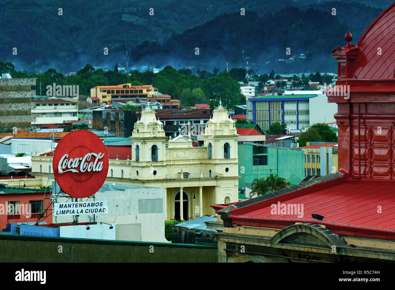 Costa Rica, San Jose, Coca-Cola Bus Stop Sign, Church of La Soledad, Red Roof  Of The National Theater Stock Photo